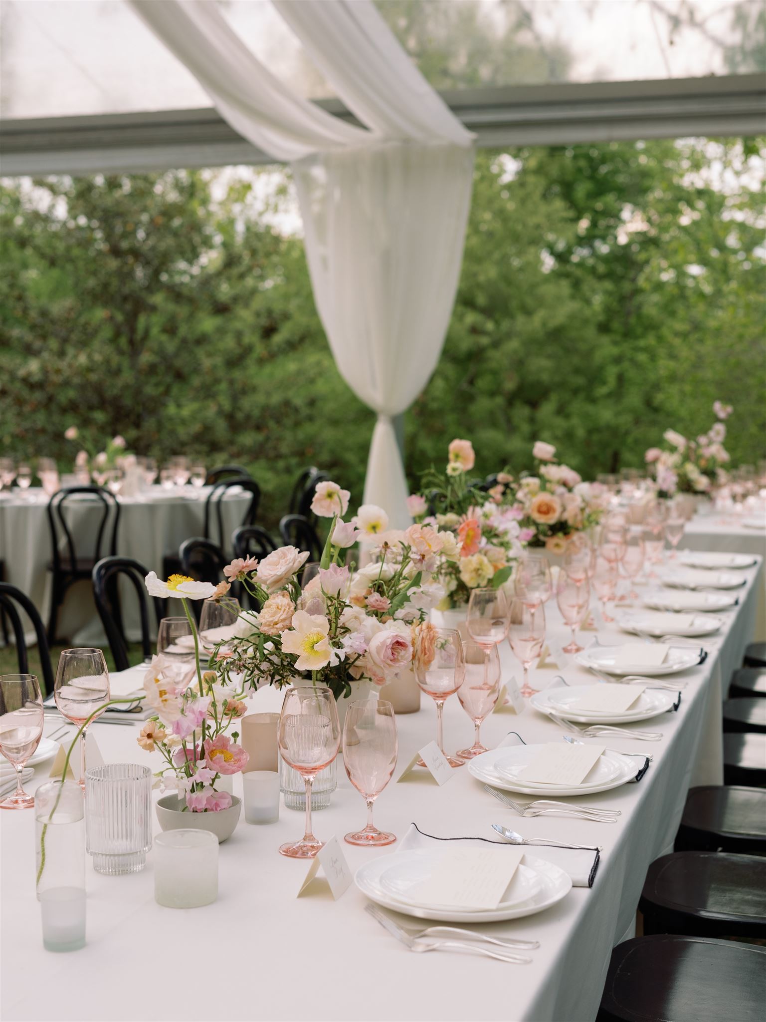 Outdoor reception tent and tables with tablescapes and floral decor from Cheekwood Spring Wedding.