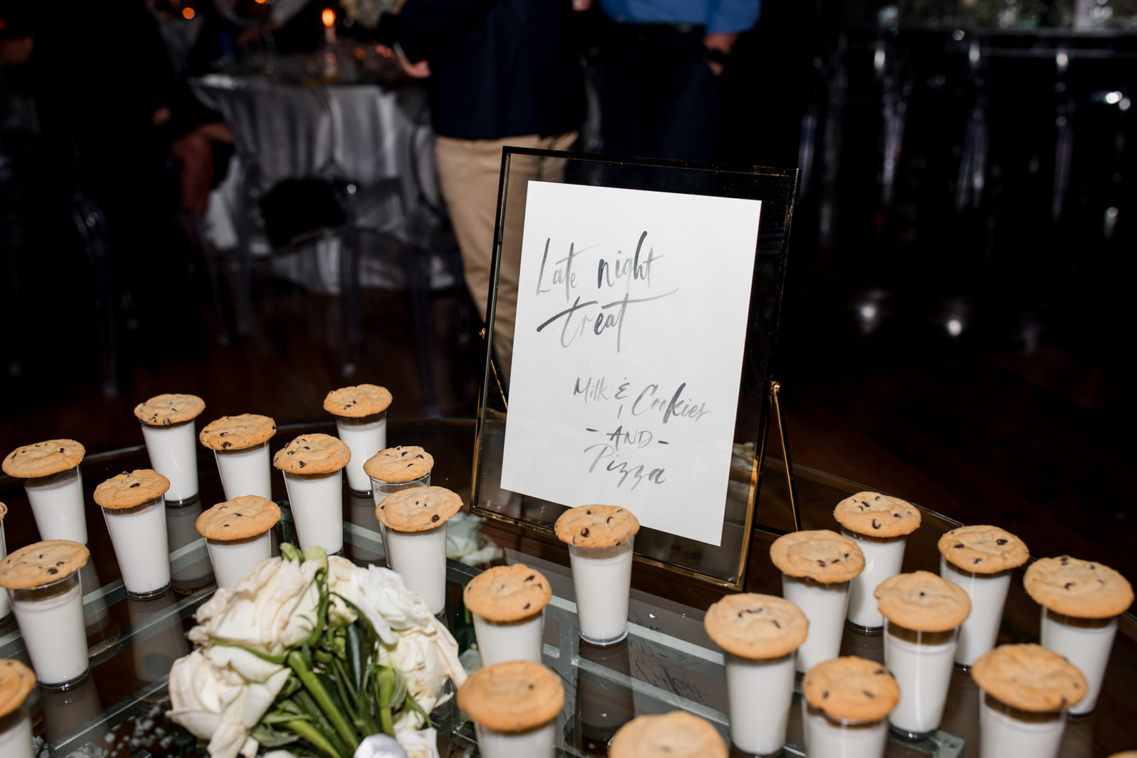 Formal table setting with custom menu tucked into napkin on plate.