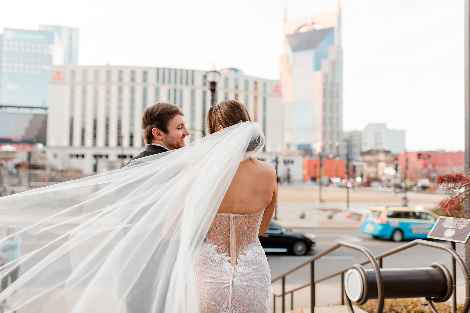 Back of bride and groom. Brides veil blowing in the wind .