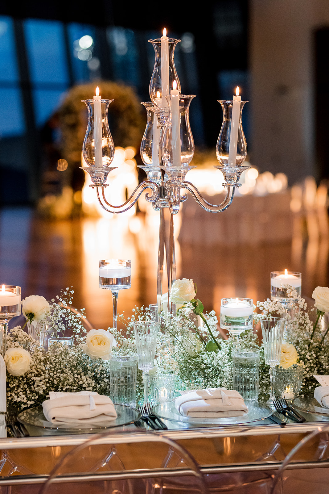 Formal table setting with custom menu tucked into napkin on plate.