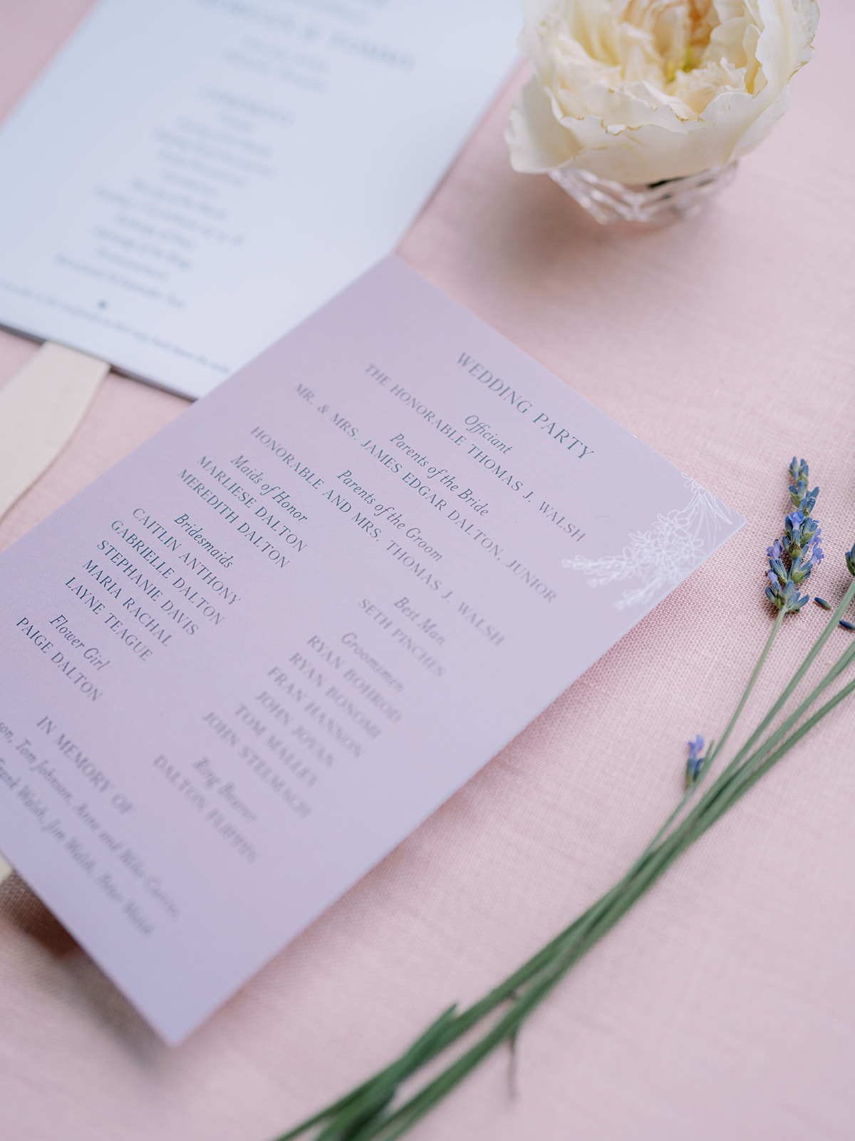 Ceremony programs with wooden handles styled with flower and lavender.