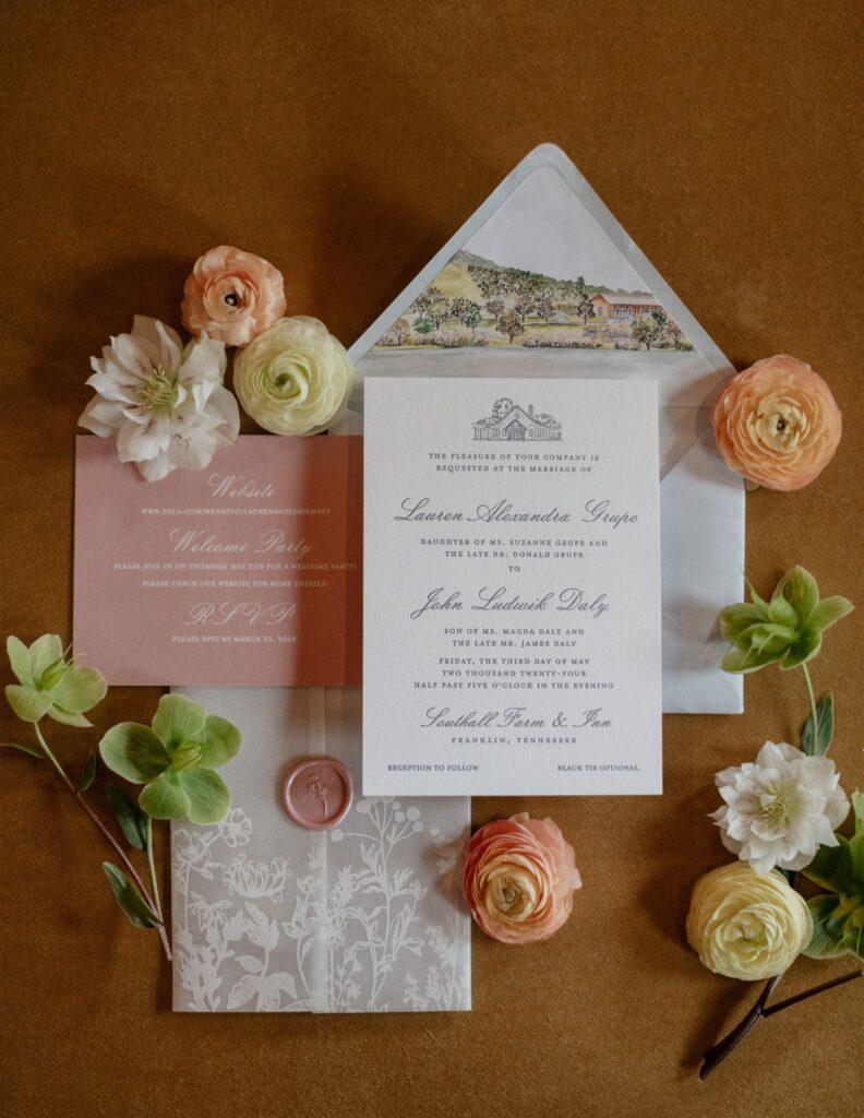 Flat lay of formal wedding invitation suite decorated with flowers.