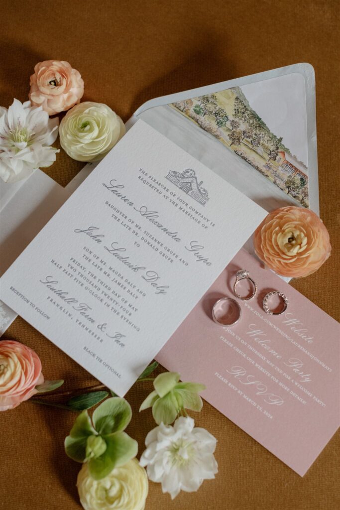 Flat lay of formal wedding invitation suite decorated with flowers.