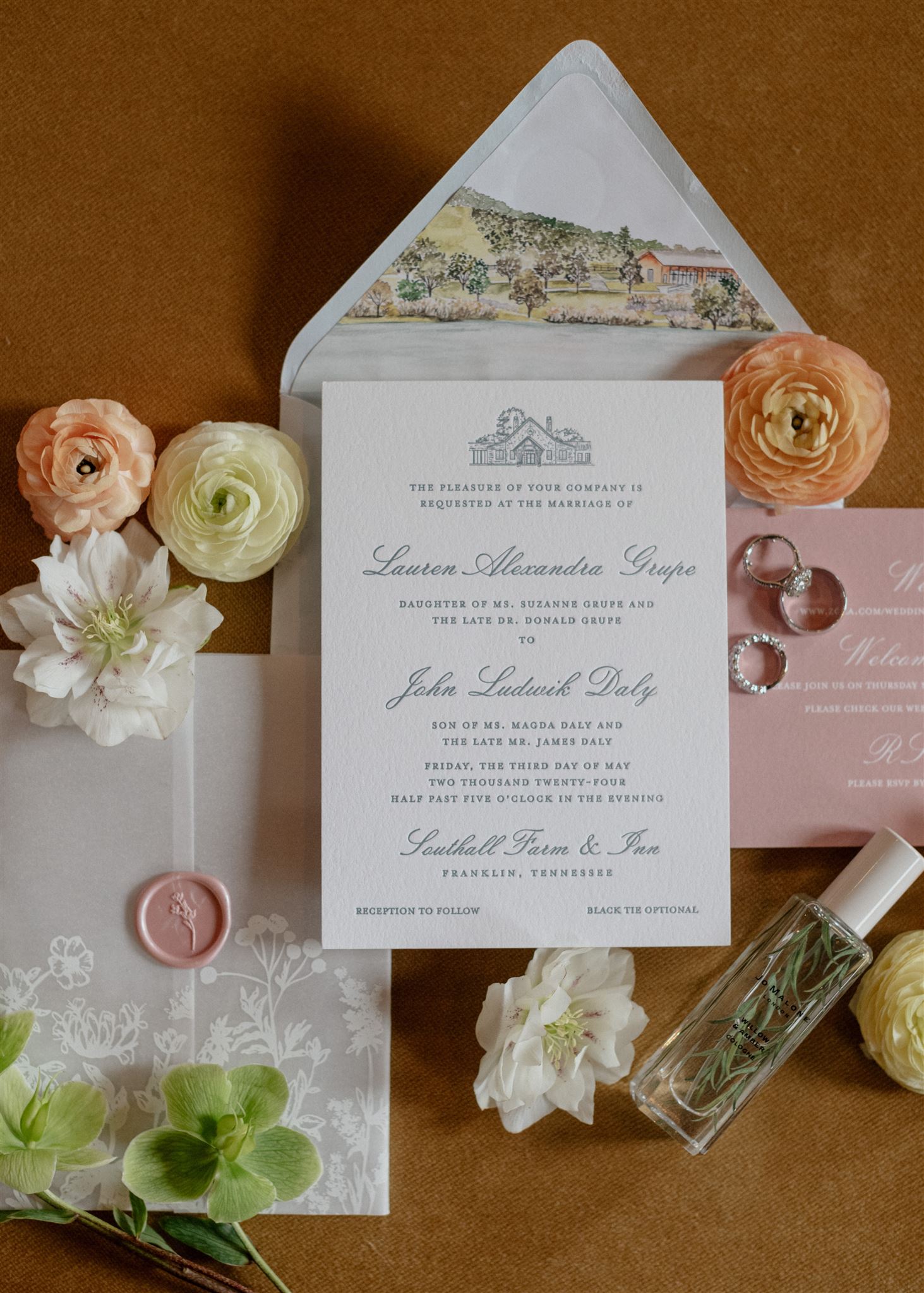 Flat lay of formal wedding invitation suite decorated with flowers.