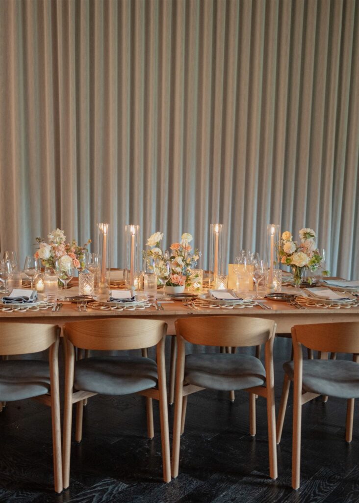 Formal reception dining place setting with table menus, candles and floral arrangements.