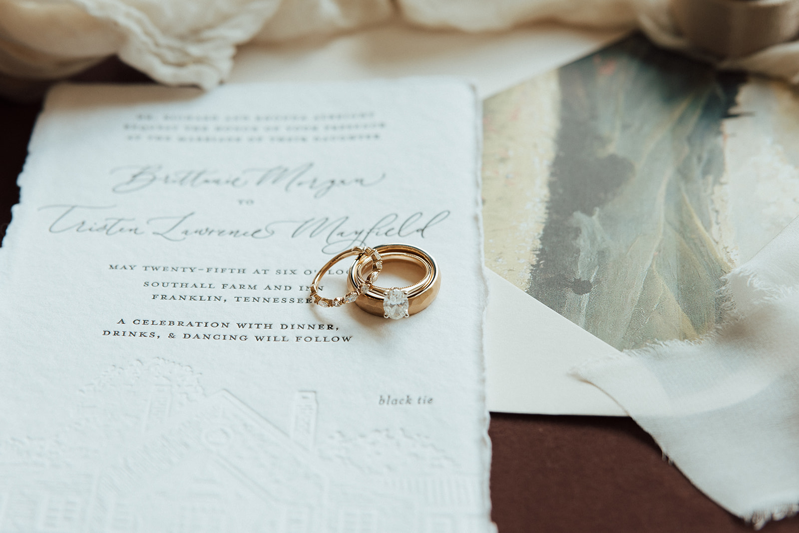 Styled flat-lay of custom wedding invitation.