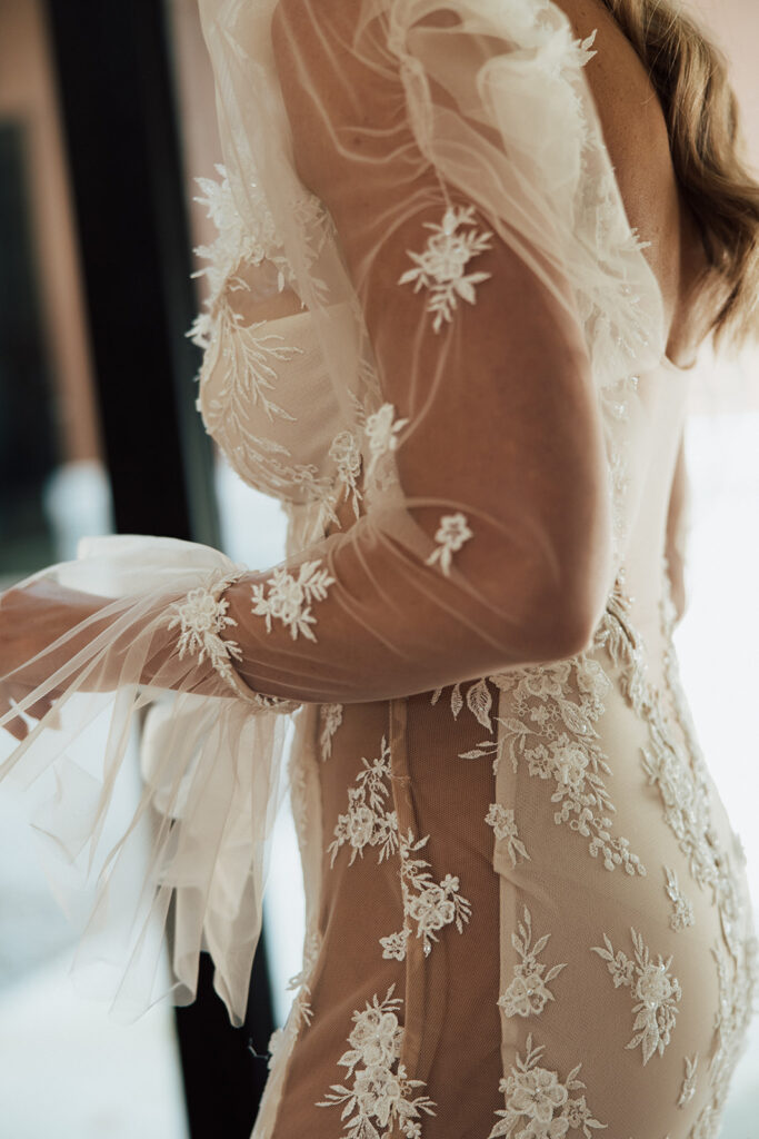 Side view of bride as she is turned to the side showing lace, tool, and embroidering.