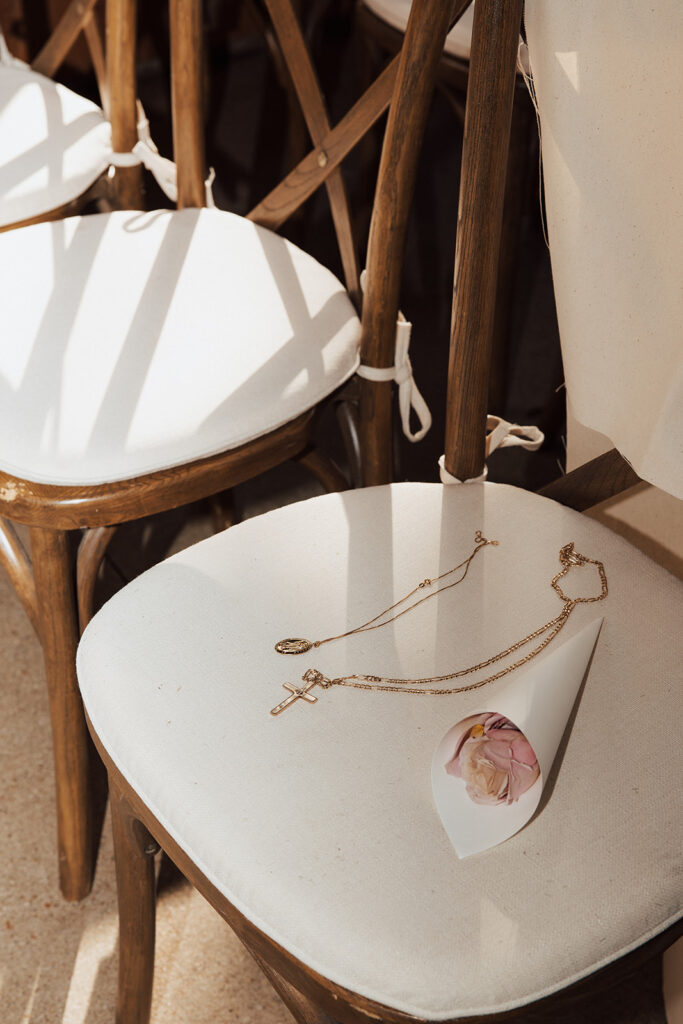 cupped flower, and two necklaces placed on top of ceremony chair to symbolize those who passed on.