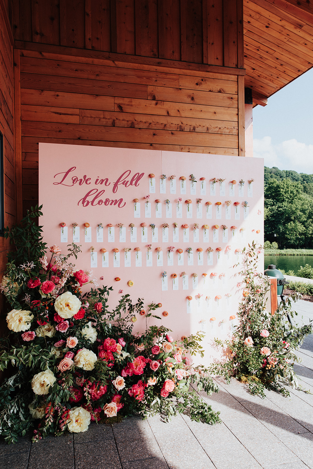 Seating chart display to include individual escort cards and flowers.