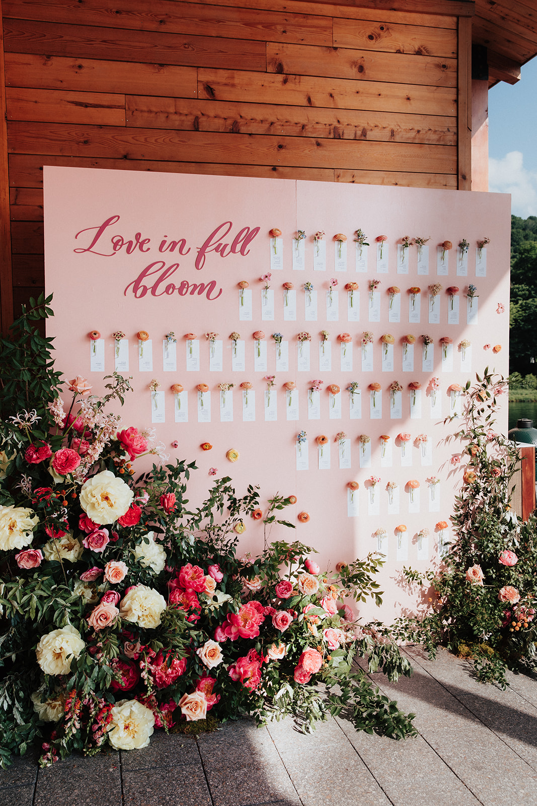 Seating chart display to include individual escort cards and flowers.