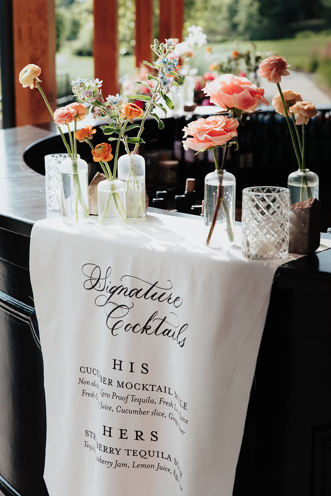 Fabric banner bar signage displaying signature cocktail menu. Textured Wedding reception Details