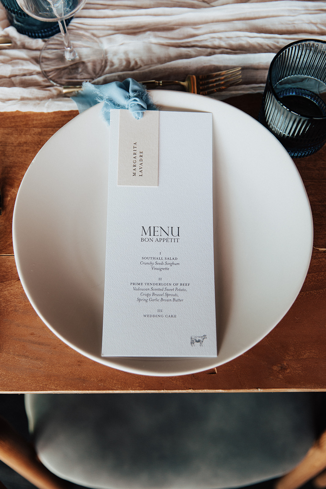 custom reception menu placed on top of plate.