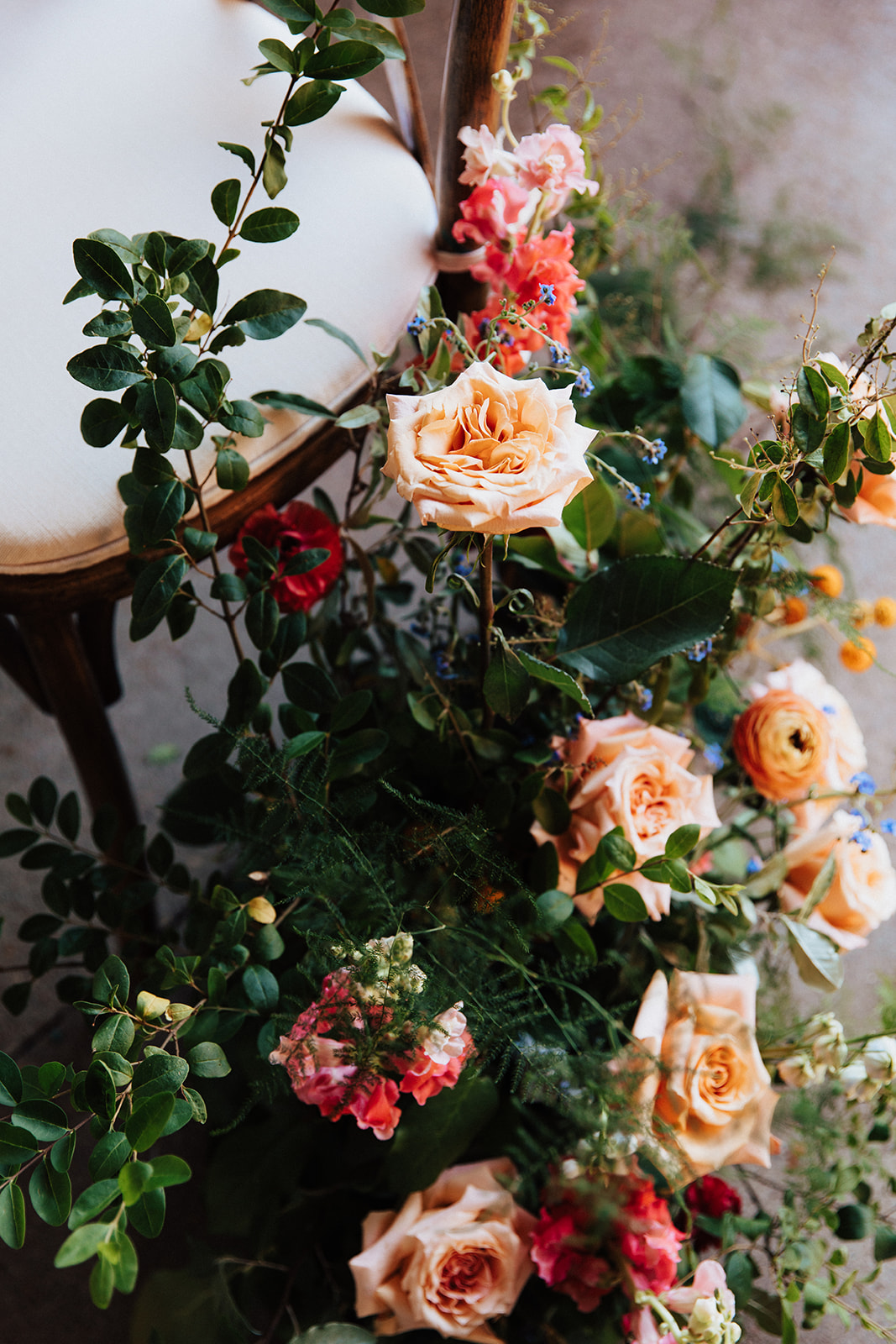 floral arrangement next to ceremony chair.