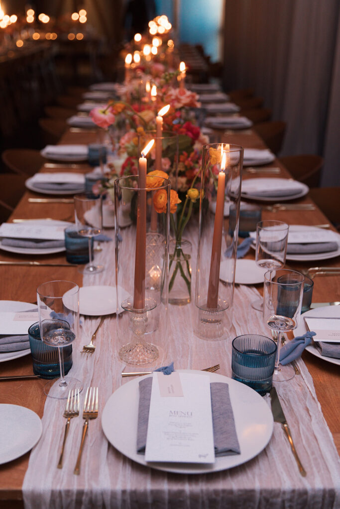 Formal reception tablescape to include candles, place settings, florals, and custom menus.