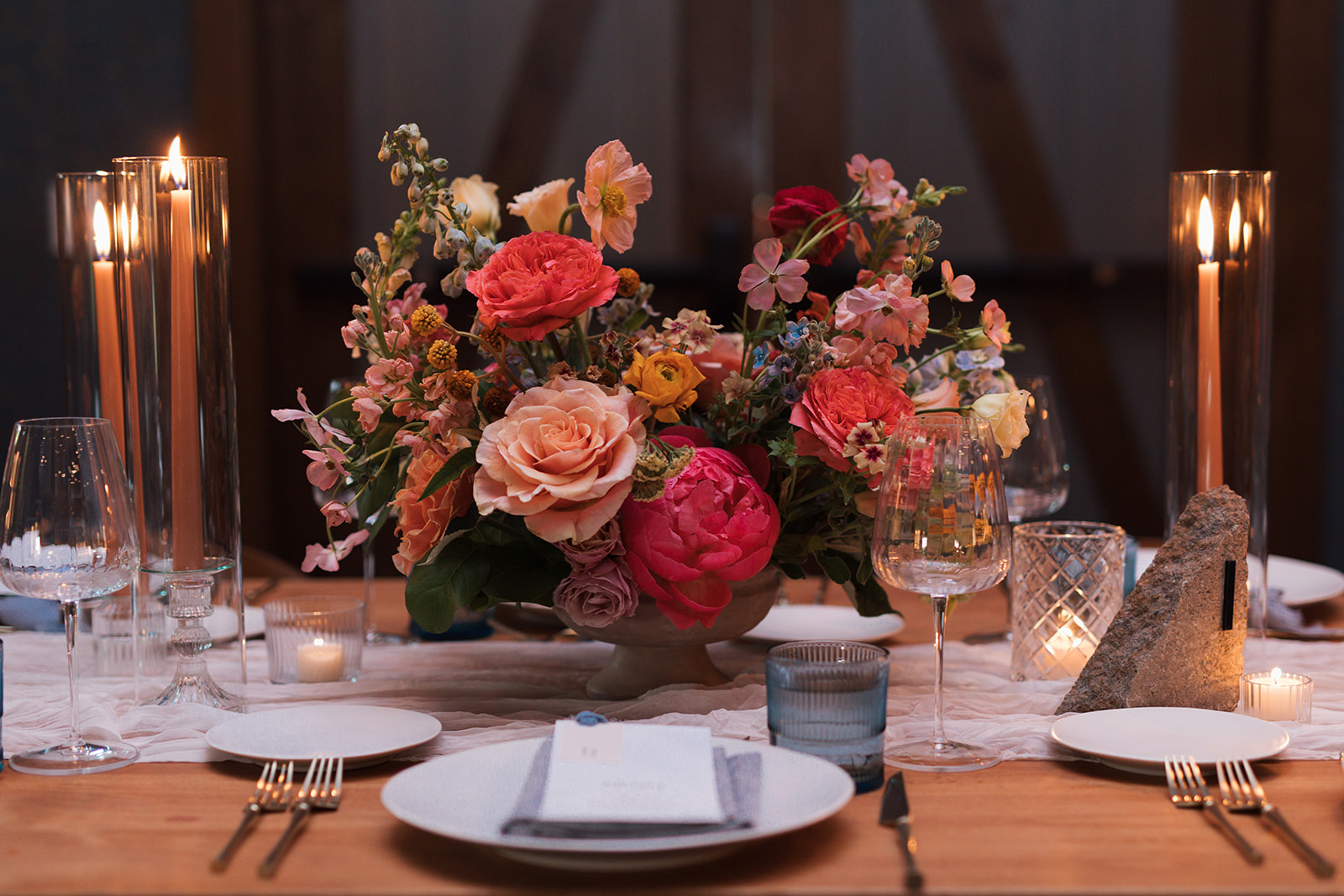 Formal reception tablescape to include candles, place settings, florals, and custom menus.