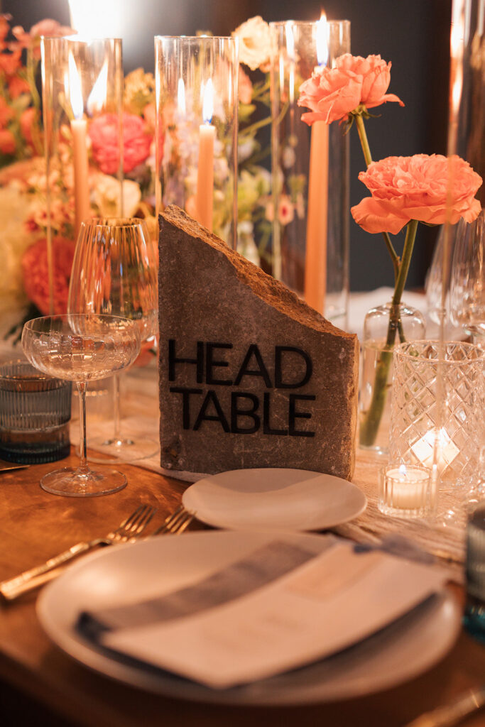 Formal reception table setting with stone, table signage in center.