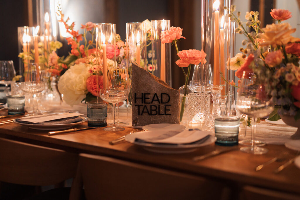 Formal reception table setting with stone, table signage in center.