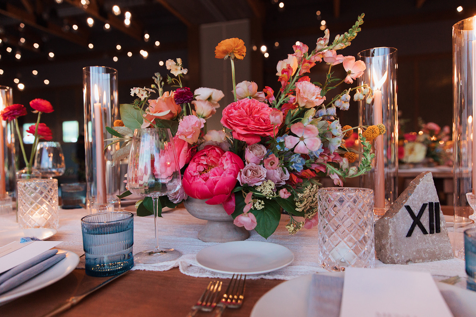 Formal reception tablescape to include candles, place settings, florals, and custom menus.