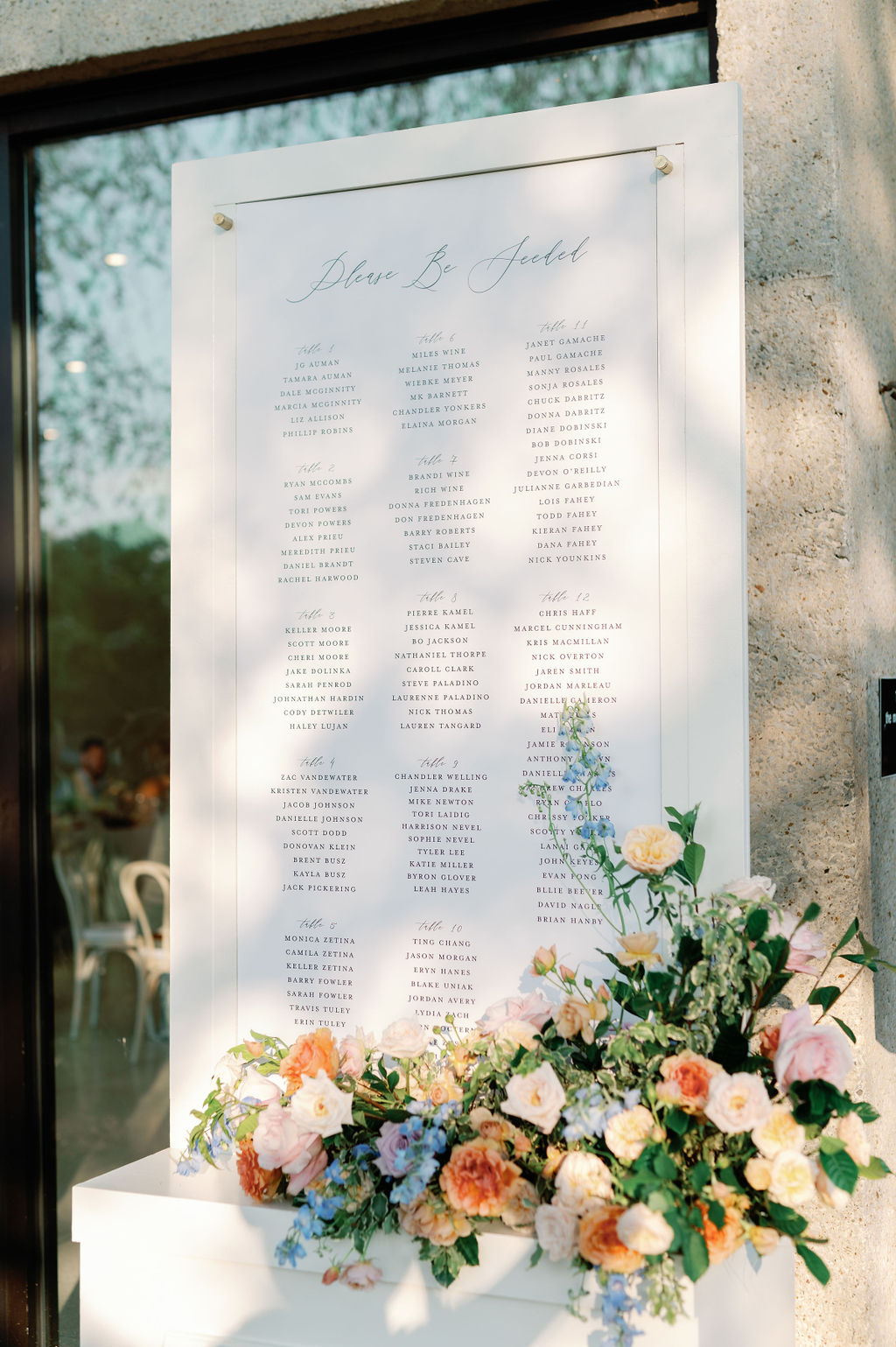 Custom reception seating chart styled with florals.