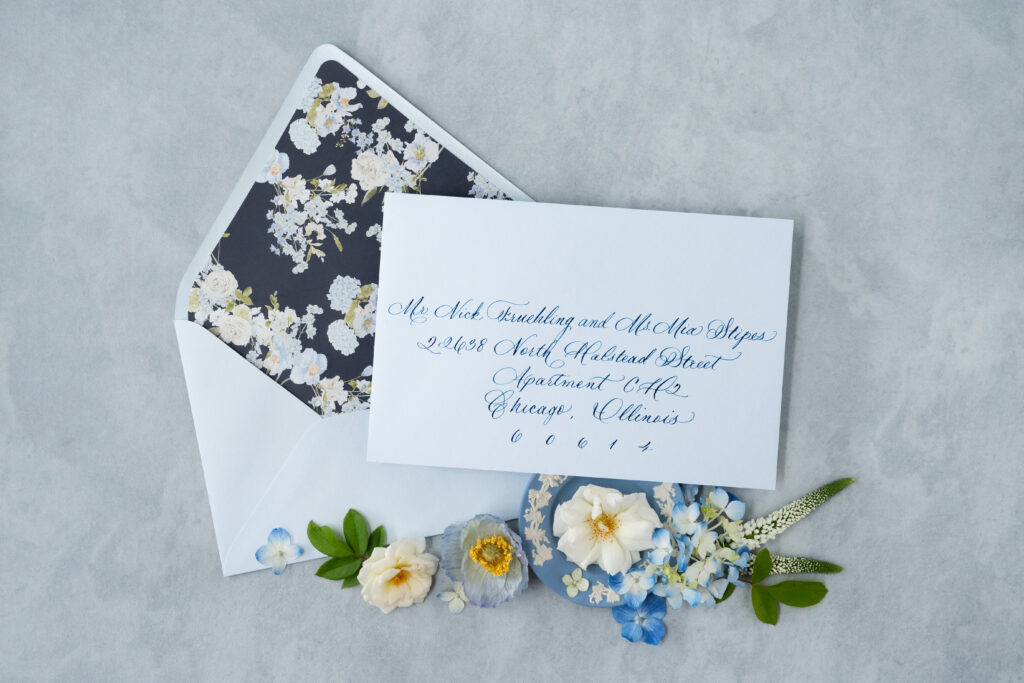 Custom wedding invitation flat lay includes envelope liner and envelope spot calligraphy