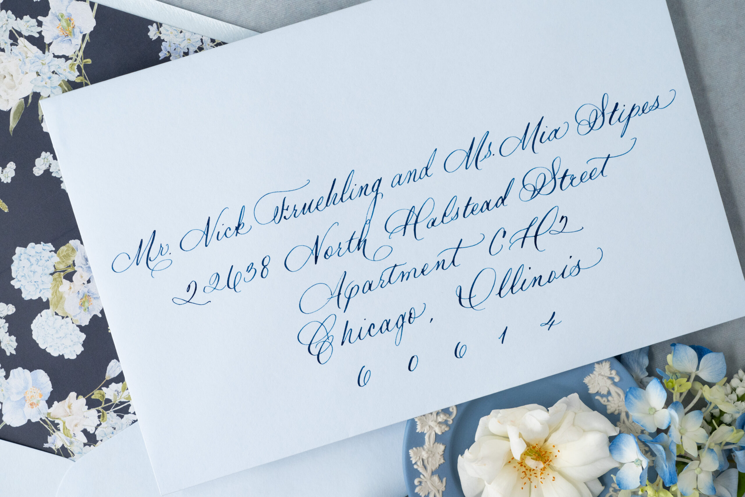 spot calligraphy atop custom wedding envelope