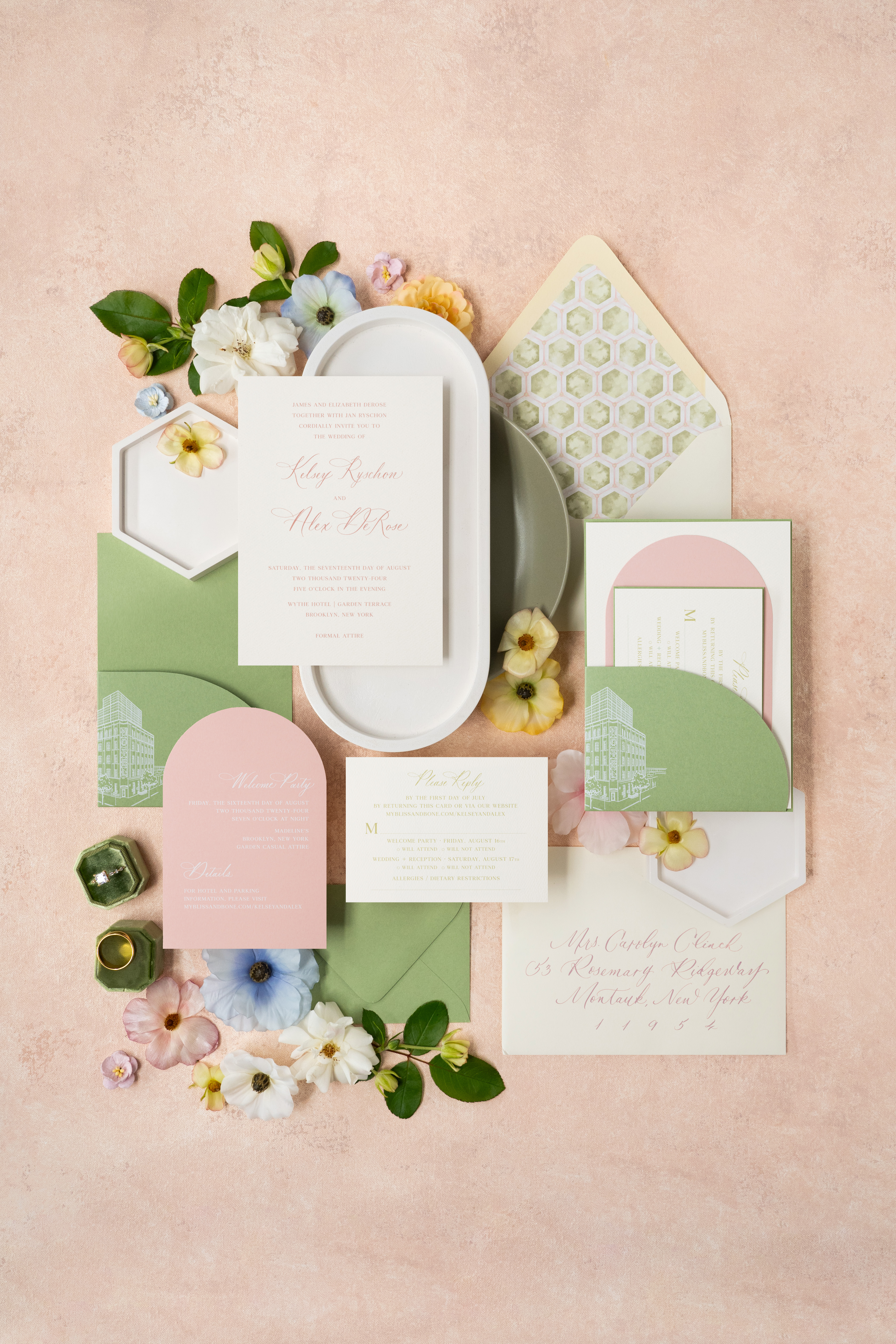 Custom wedding invitation suite showcasing custom die-cut pocket, custom architectural sketch, summer pinks, greens, envelope calligraphy, and custom envelope liner.