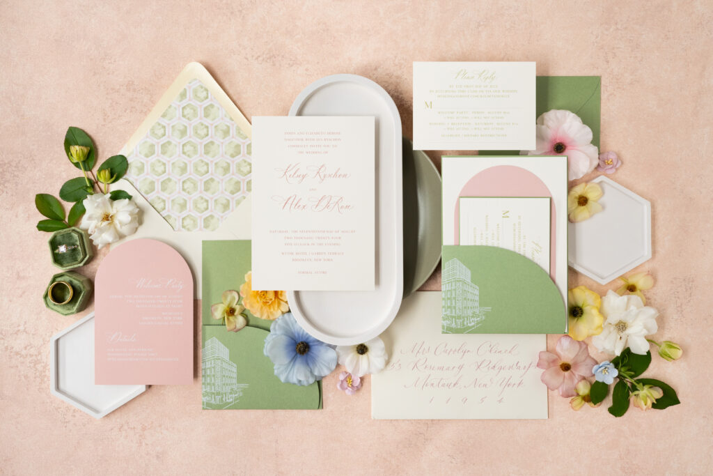 Custom wedding invitation suite showcasing custom die-cut pocket, custom architectural sketch, summer pinks, greens, envelope calligraphy, and custom envelope liner.