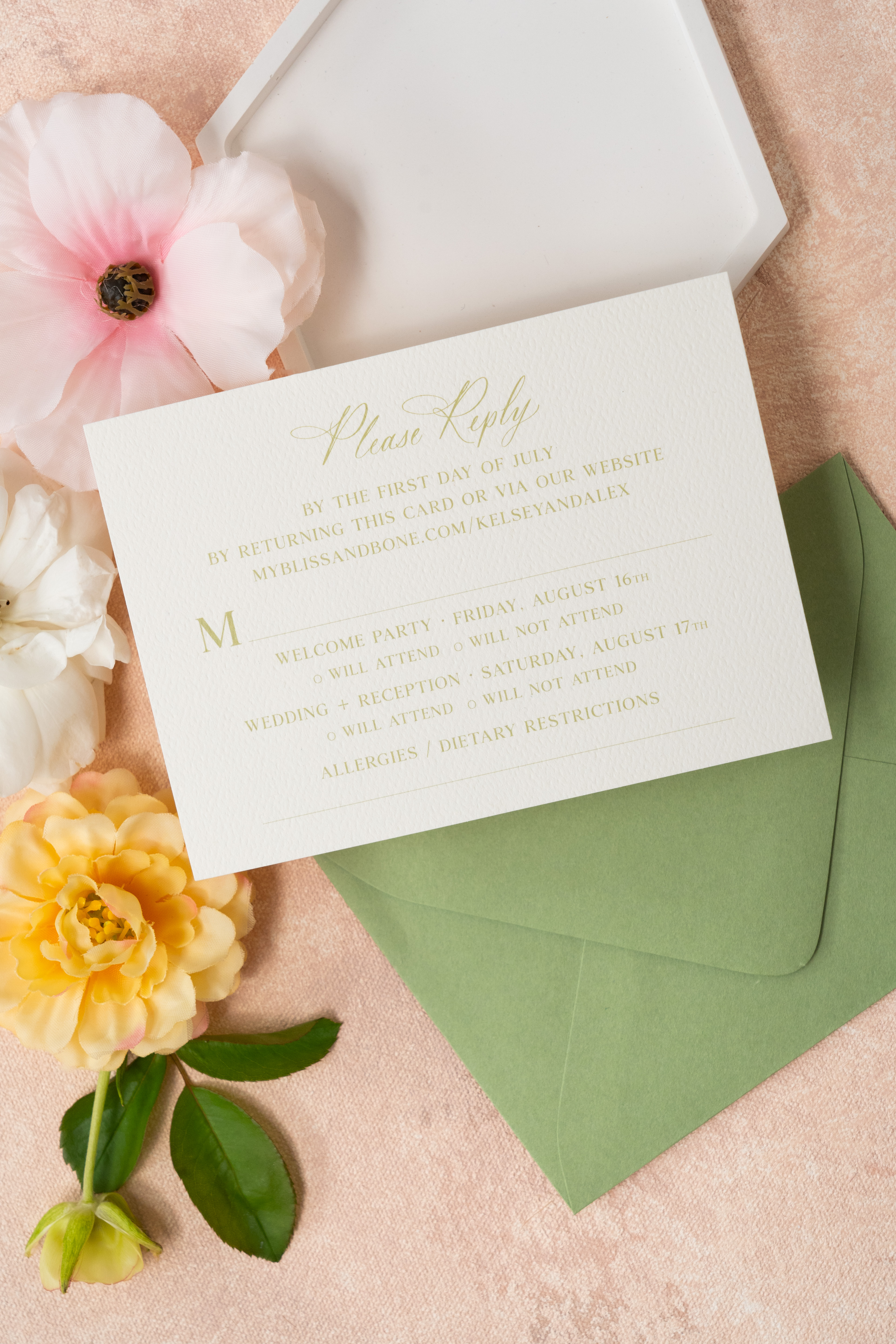 flat lay of custom wedding invitation reply card. styled with florals.