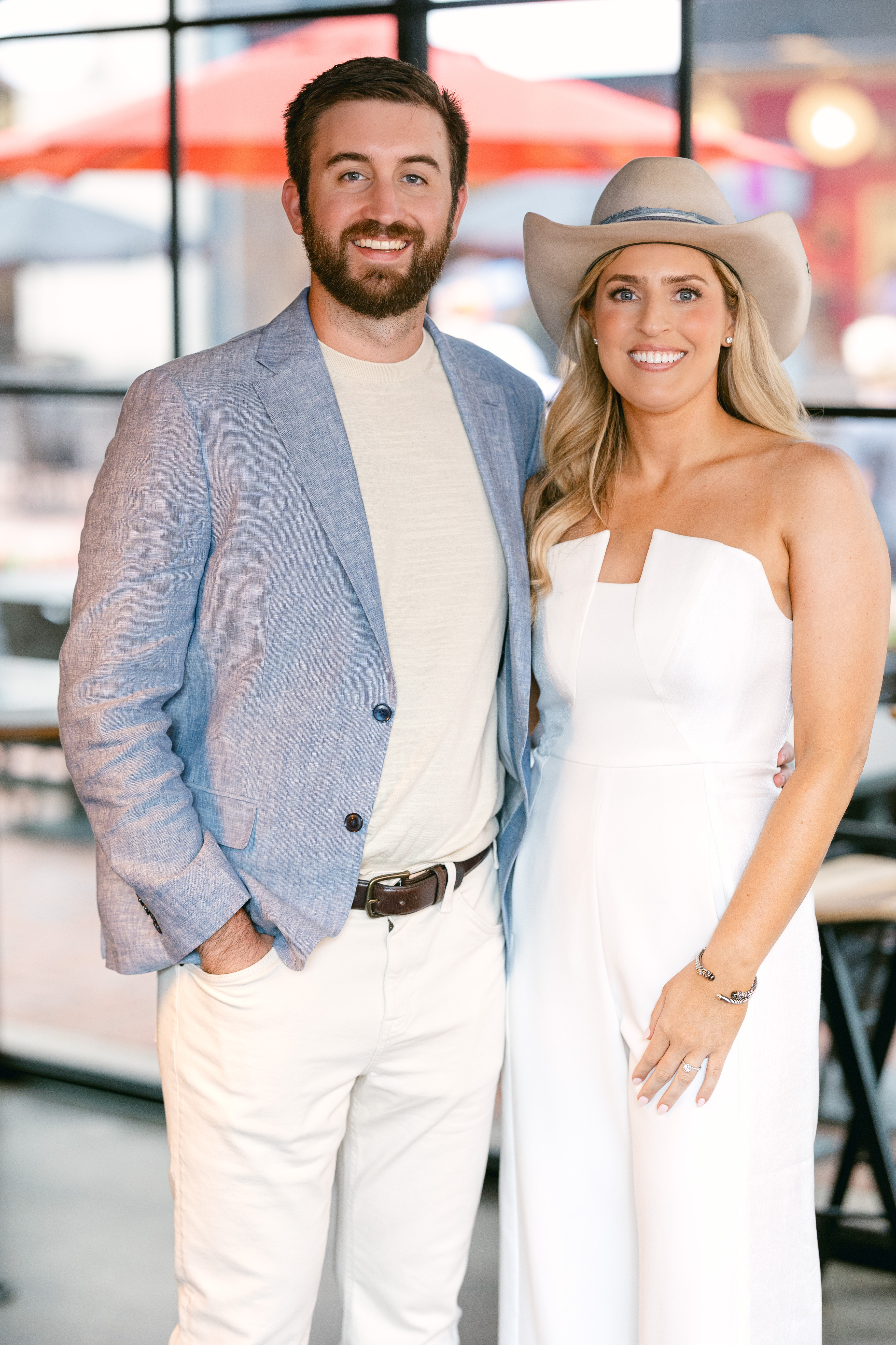 Bride and groom-to-be stand for photo at their rehearsal dinner. 