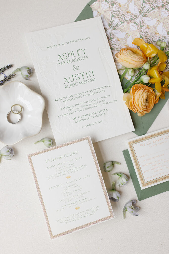 wedding invitation suite includes custom artwork envelope liner, custom designed framing. flat lay styled with soft florals.