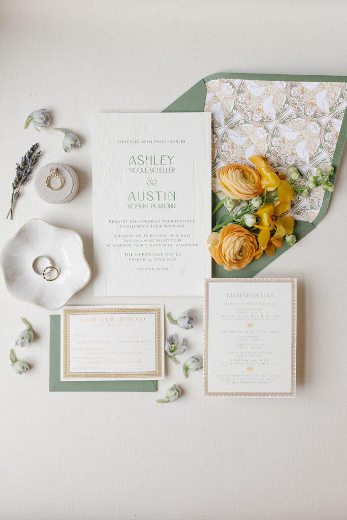 wedding invitation suite includes custom artwork envelope liner, custom designed framing. flat lay styled with soft florals.