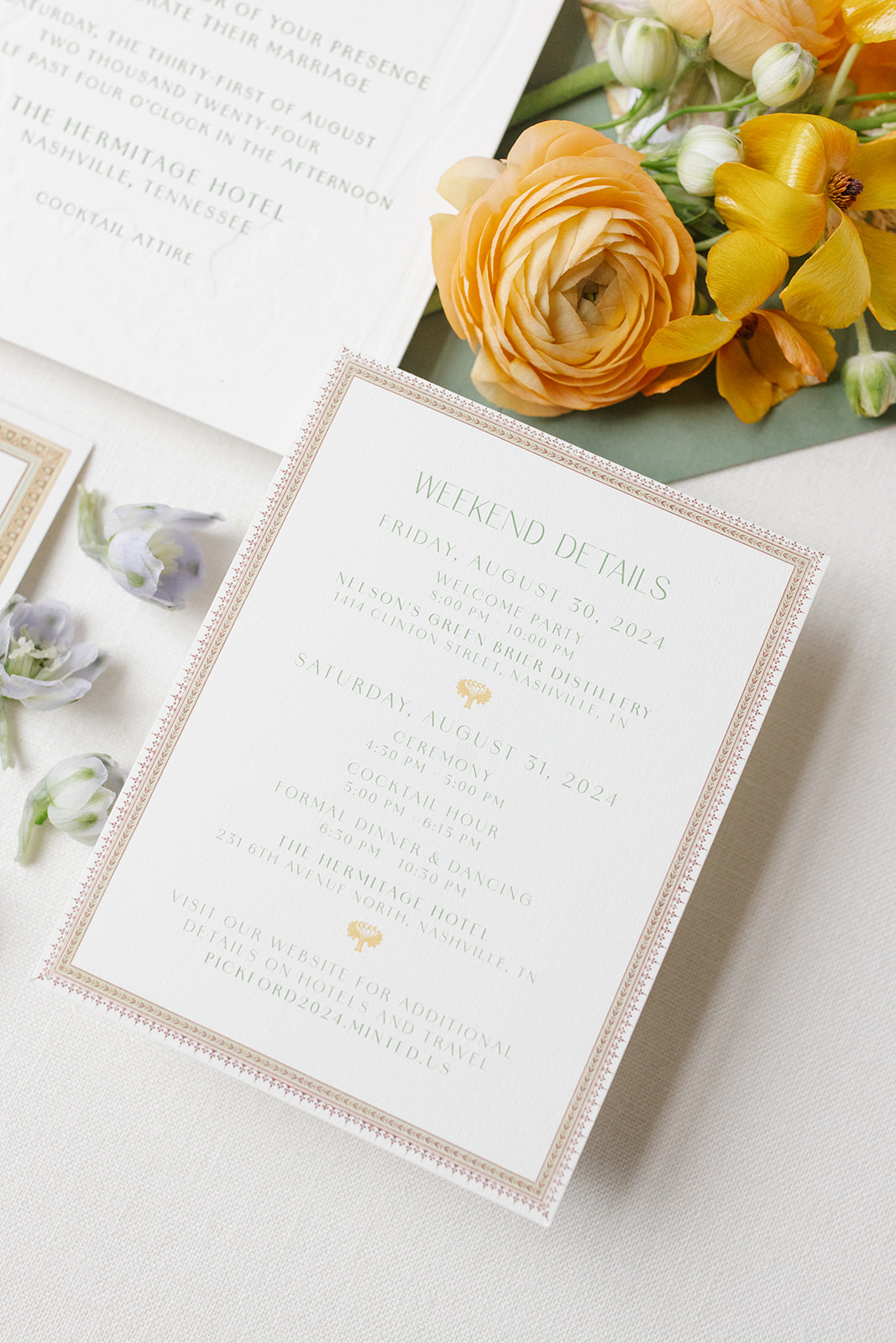 wedding invitation suite includes custom artwork envelope liner, custom designed framing. flat lay styled with soft florals.