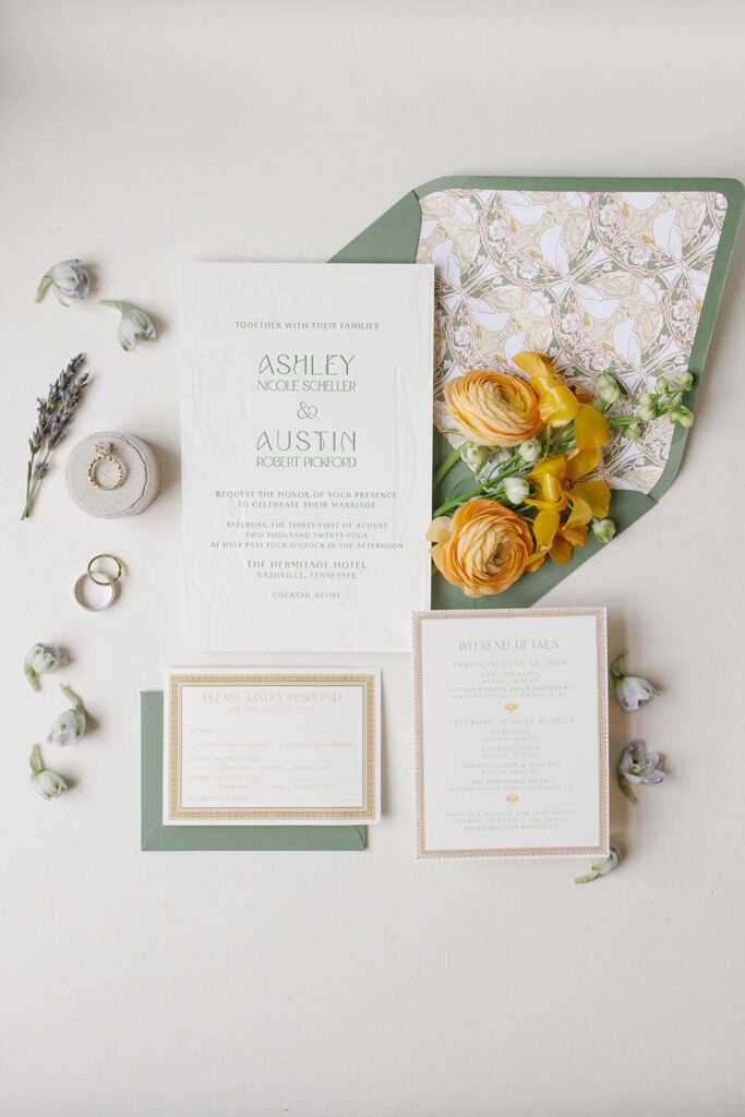 wedding invitation suite includes custom artwork envelope liner, custom designed framing. flat lay styled with soft florals.