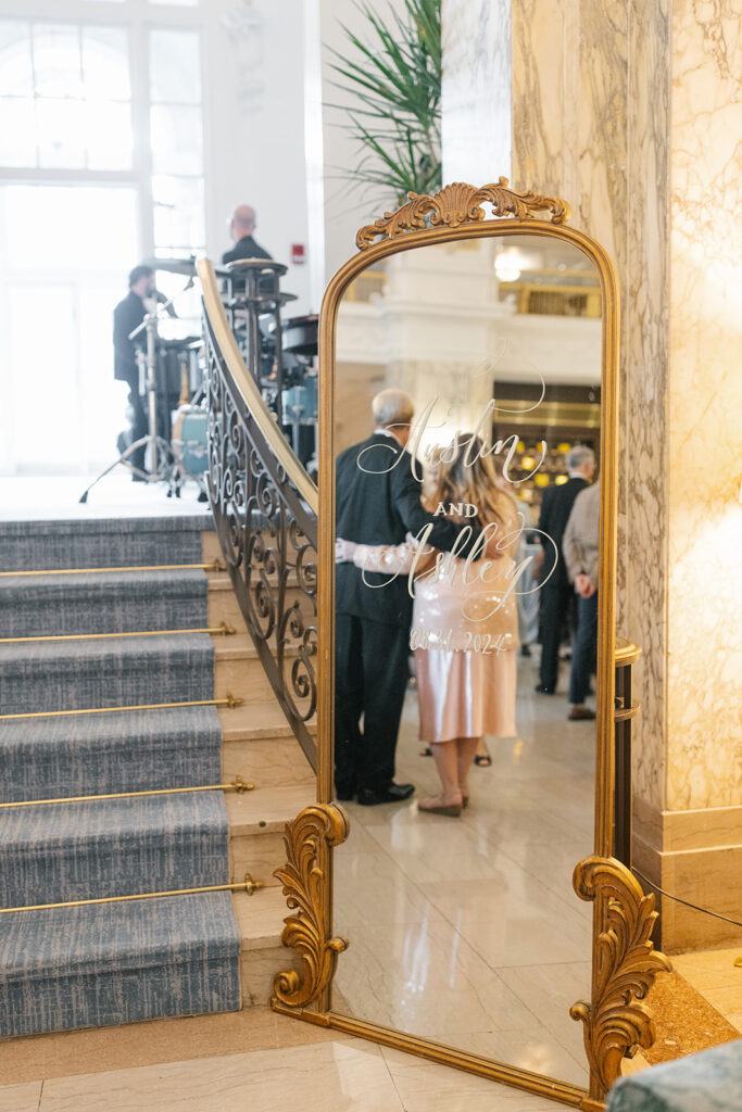 Mirror wedding welcome signage showing the reflection of guests.