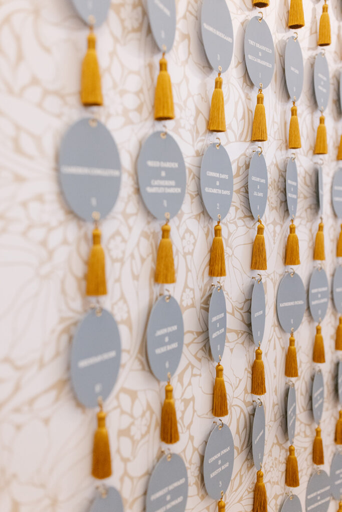 Custom die-cut menu placed atop recption table plate setting. includes place card, and yellow chiffon ribbon.