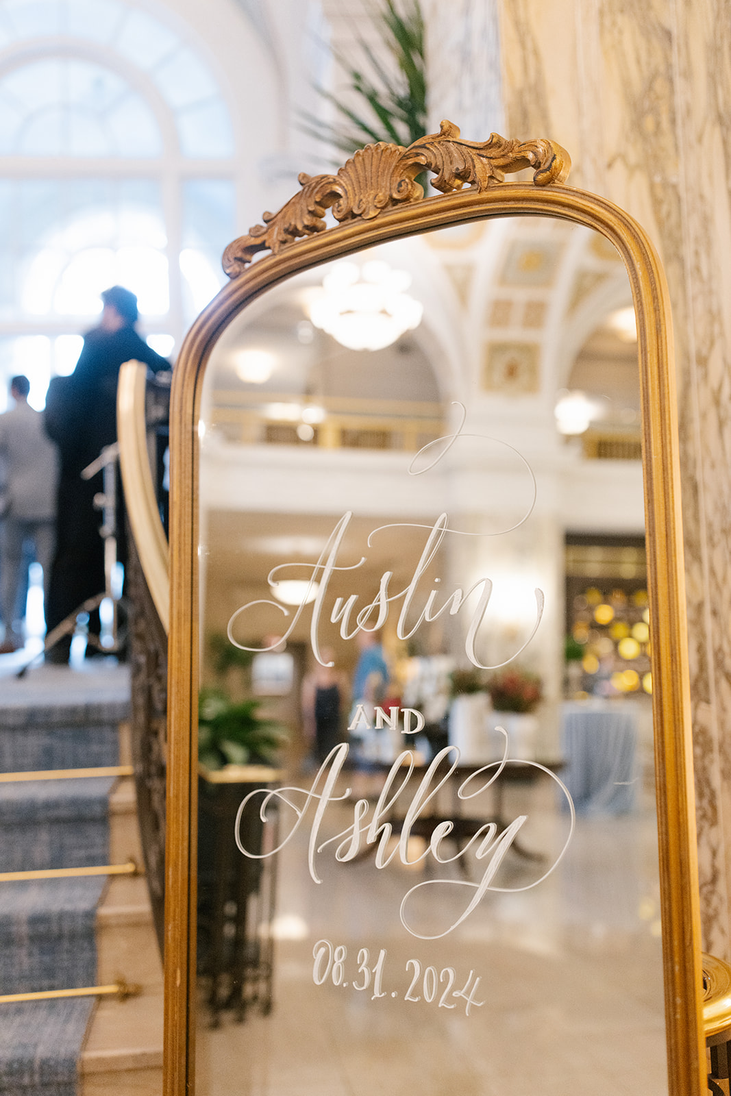 Mirror wedding welcome signage showing the reflection of guests.