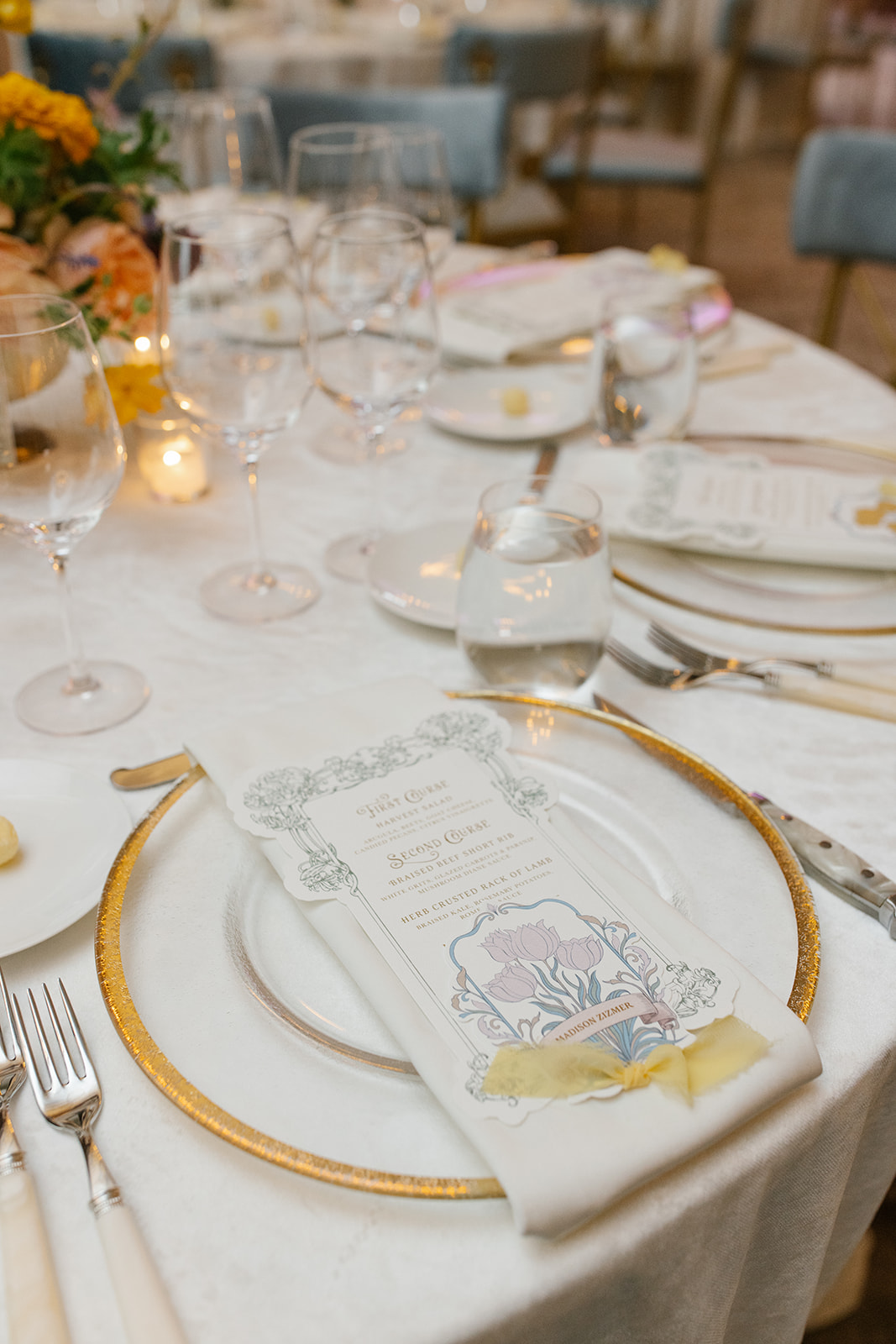 Custom die-cut menu placed atop recption table plate setting. includes place card, and yellow chiffon ribbon.