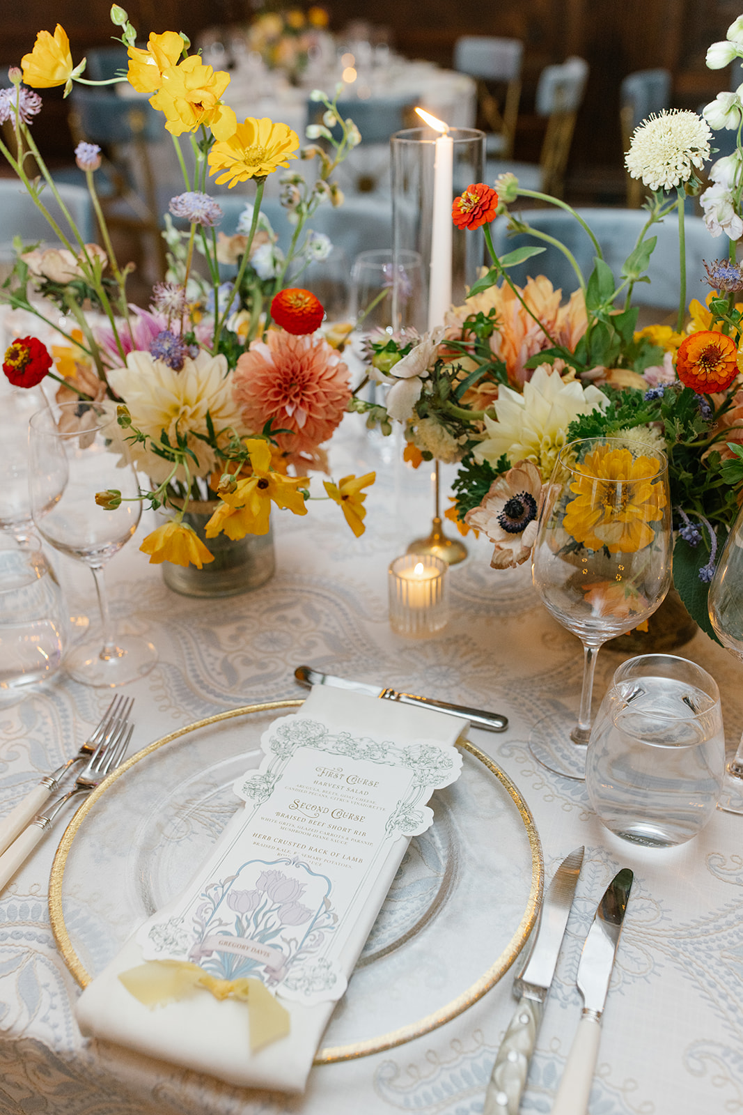 Custom die-cut menu placed atop recption table plate setting. includes place card, and yellow chiffon ribbon.