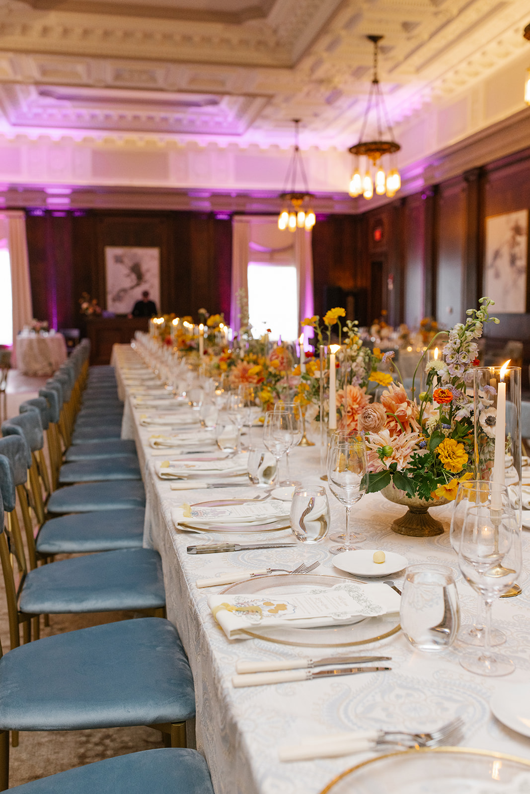 Custom die-cut menu placed atop recption table plate setting. includes place card, and yellow chiffon ribbon.