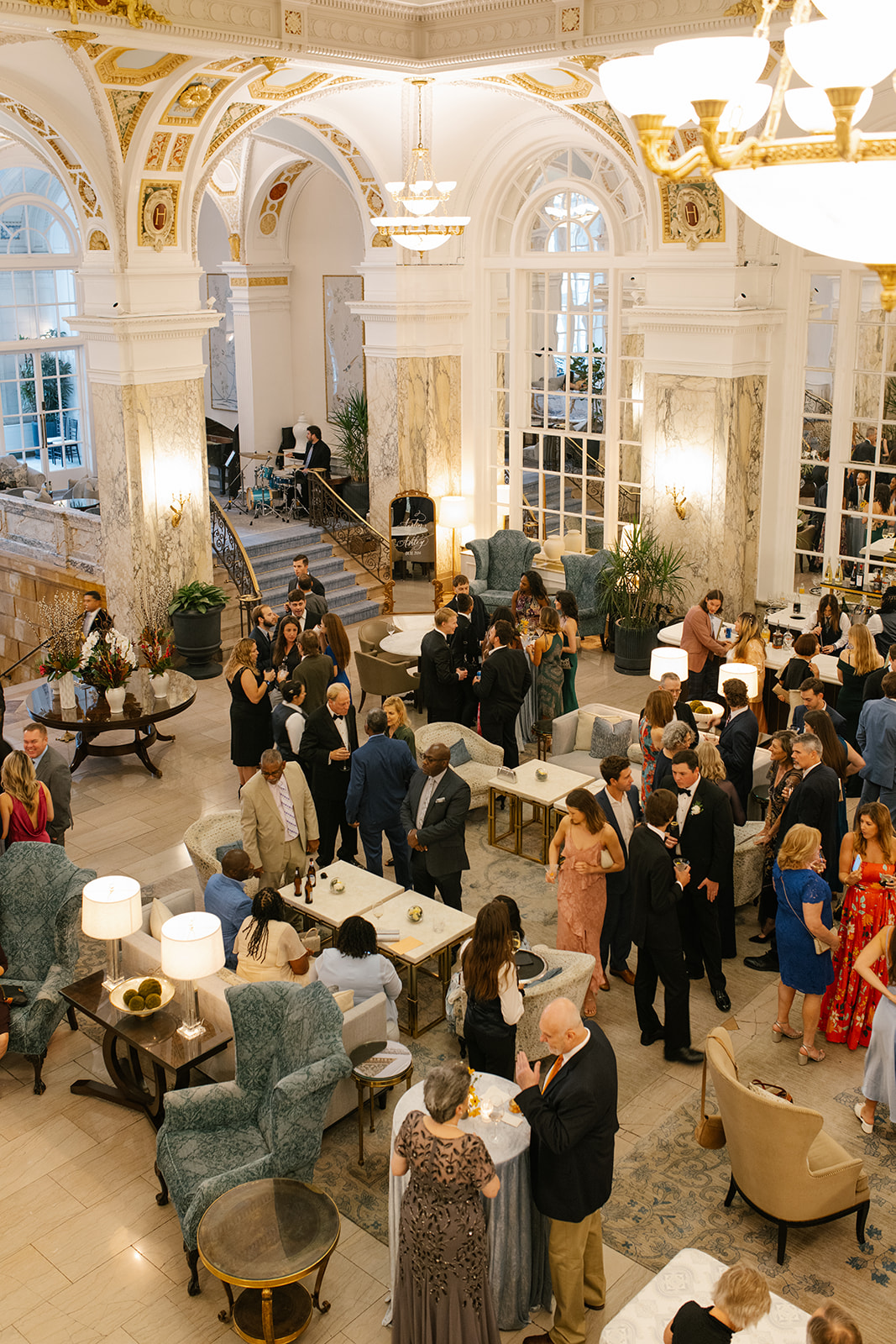 Guests gather inside The Hermitage Hotel lobby for cocktail hour.