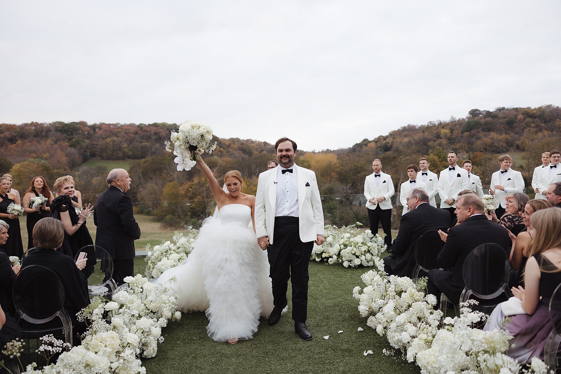 newlyweds celebrate as they exit wedding ceremony 