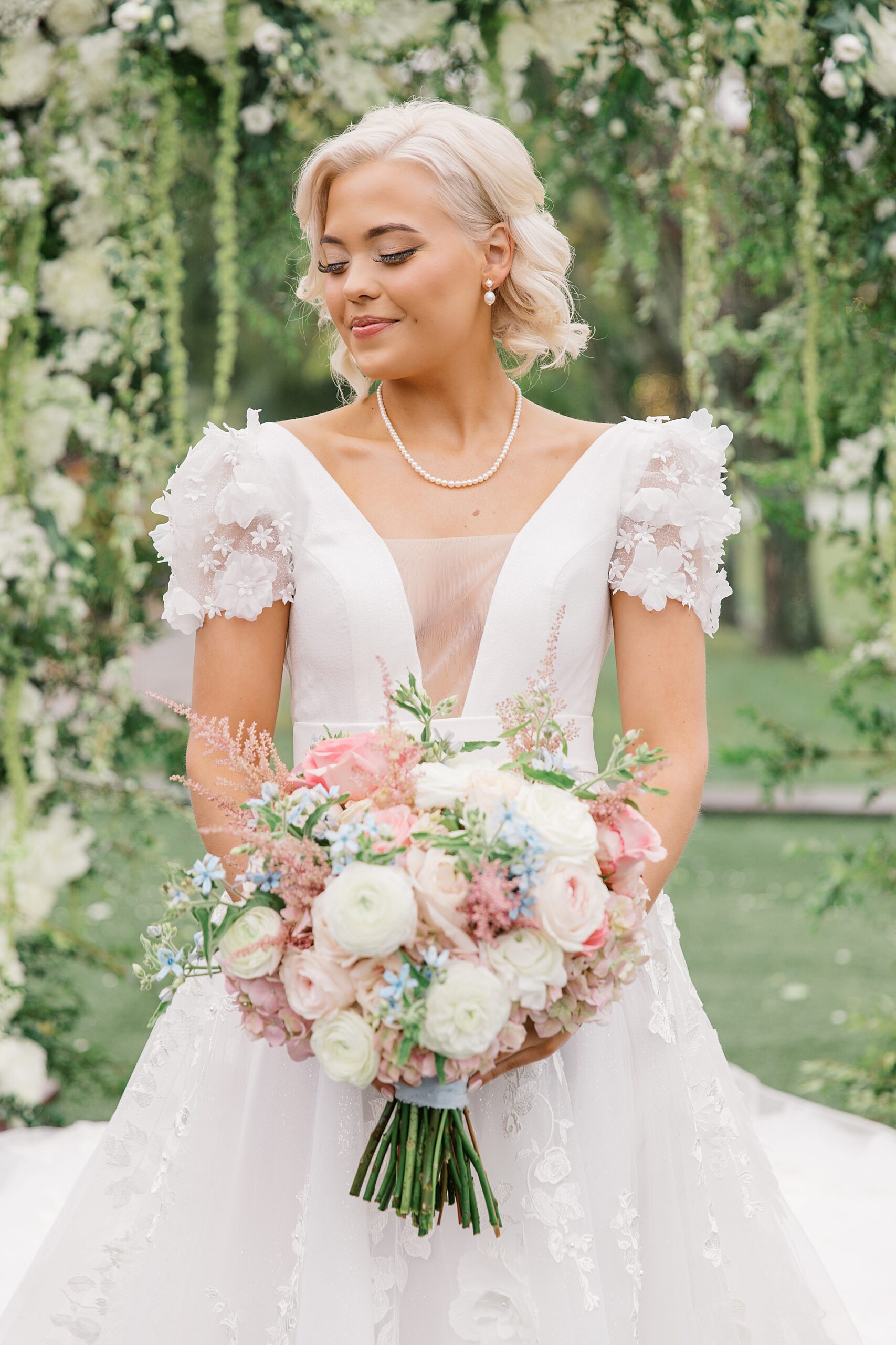 elegant bride holding soft floral bouquet