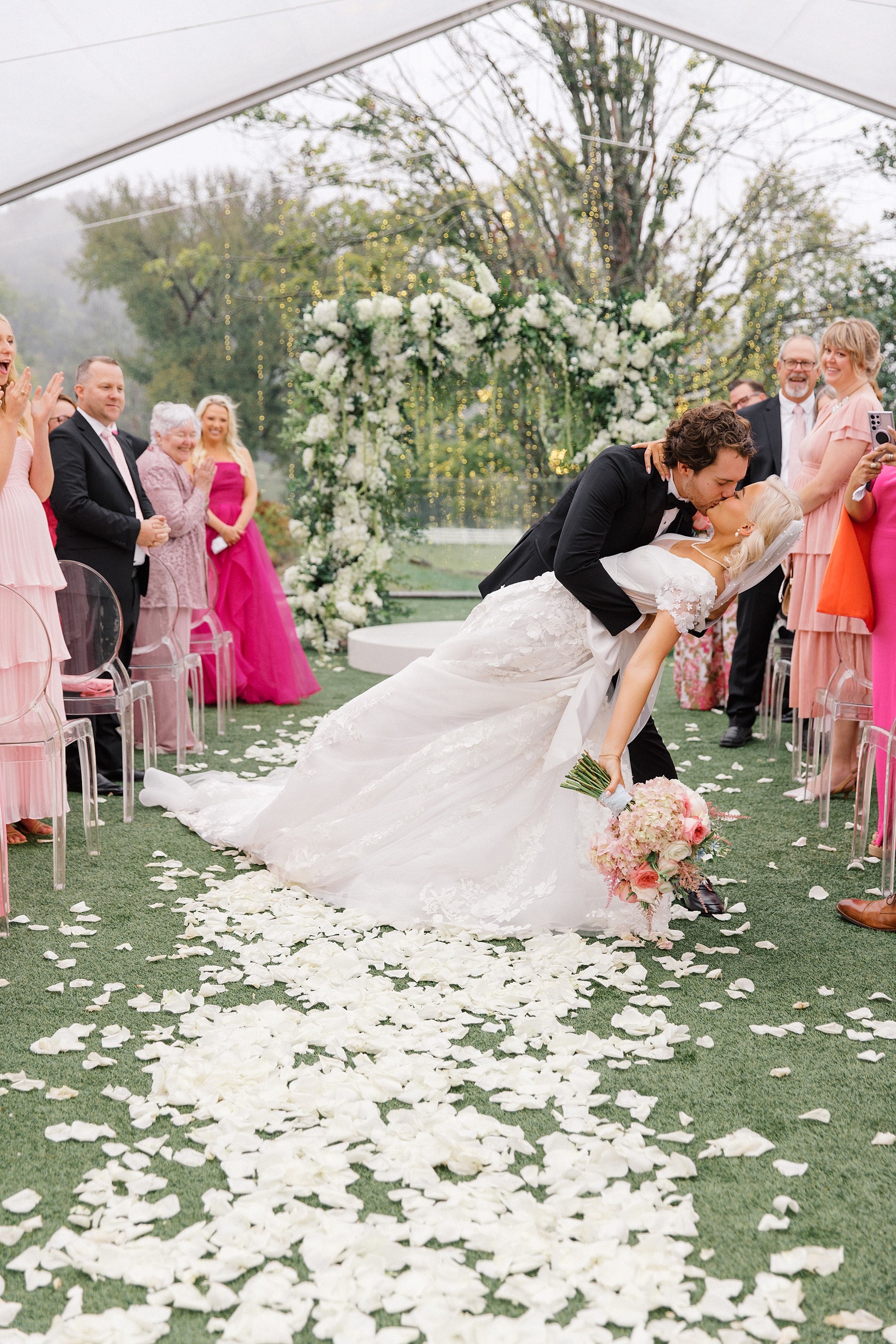 newlyweds kiss as they exit wedding ceremony 