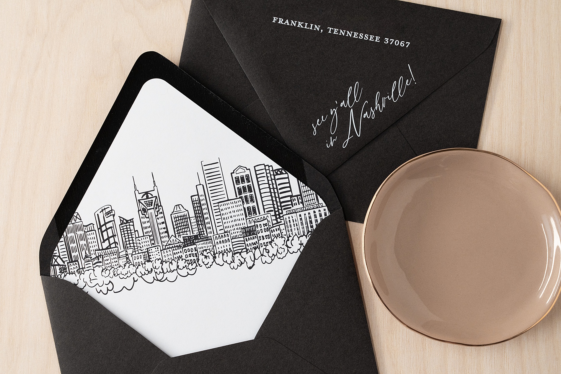 custom save the date envelope with a sketch of the Nashville skyline 