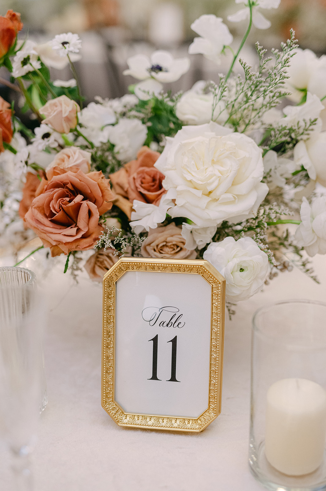 table numbers framed in gold frames with elegant bouquets 