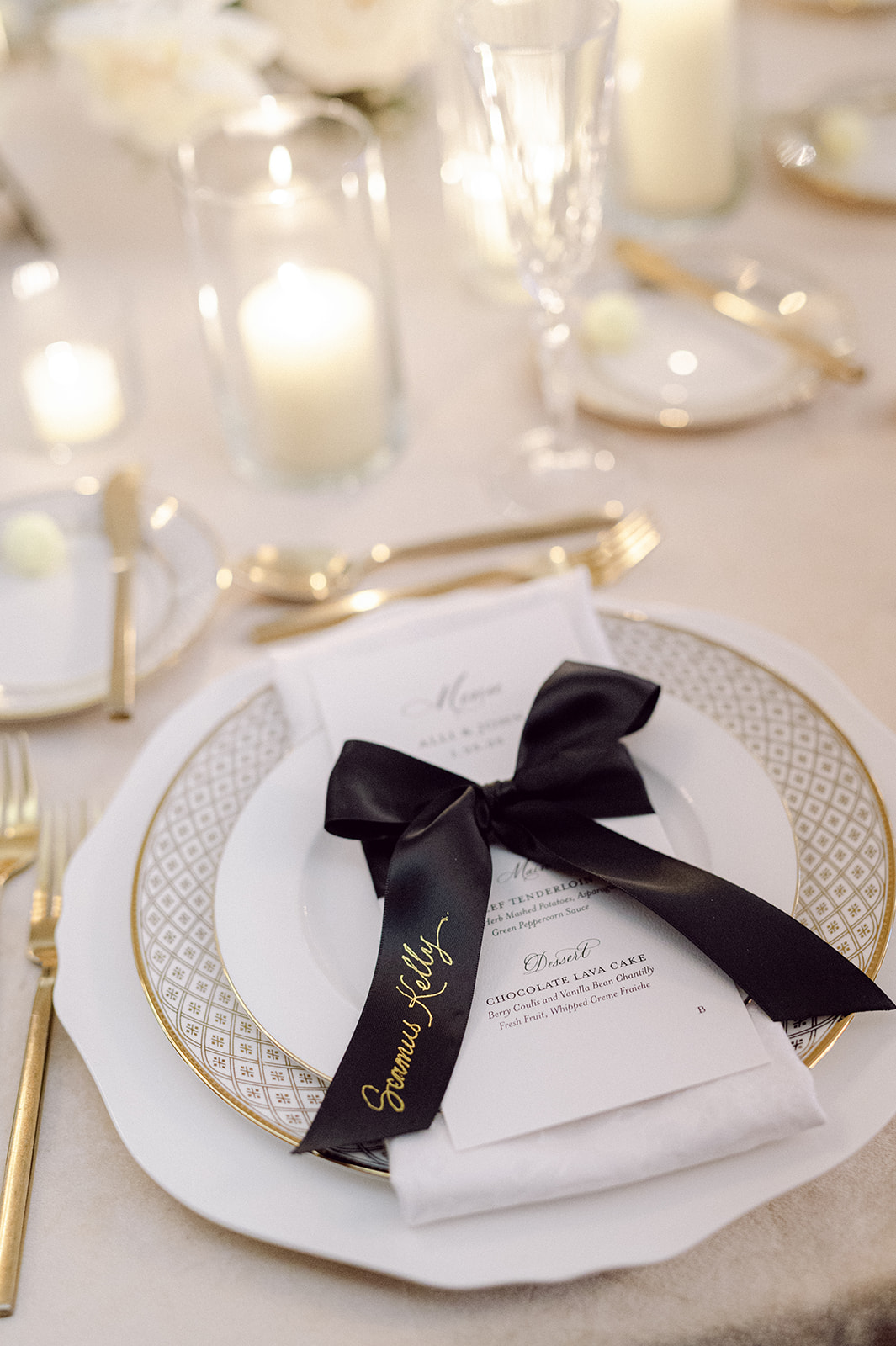 black ribbon place cards tied around custom menus featuring hand lettered hot foiled calligraphy  