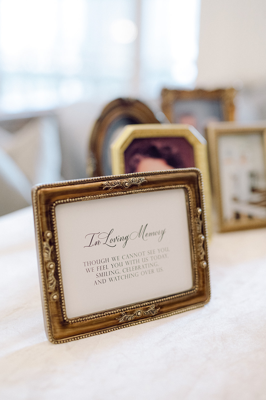 In Loving Memory wedding sign in black calligraphy framed in vintage gold frame